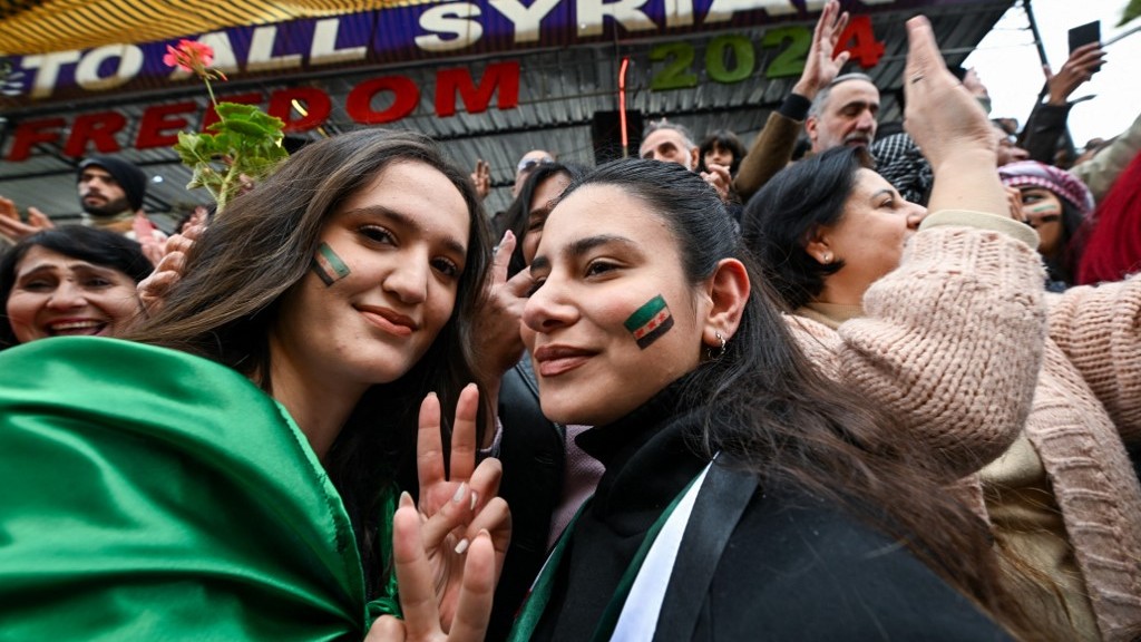 People celebrate the collapse of Bashar al-Assad’s rule while gathering on a street in Sweida on December 13, 2024. Islamist-led rebels took Damascus in a lightning offensive on December 8, ousting president Bashar al-Assad and ending five decades of Baath rule in Syria.