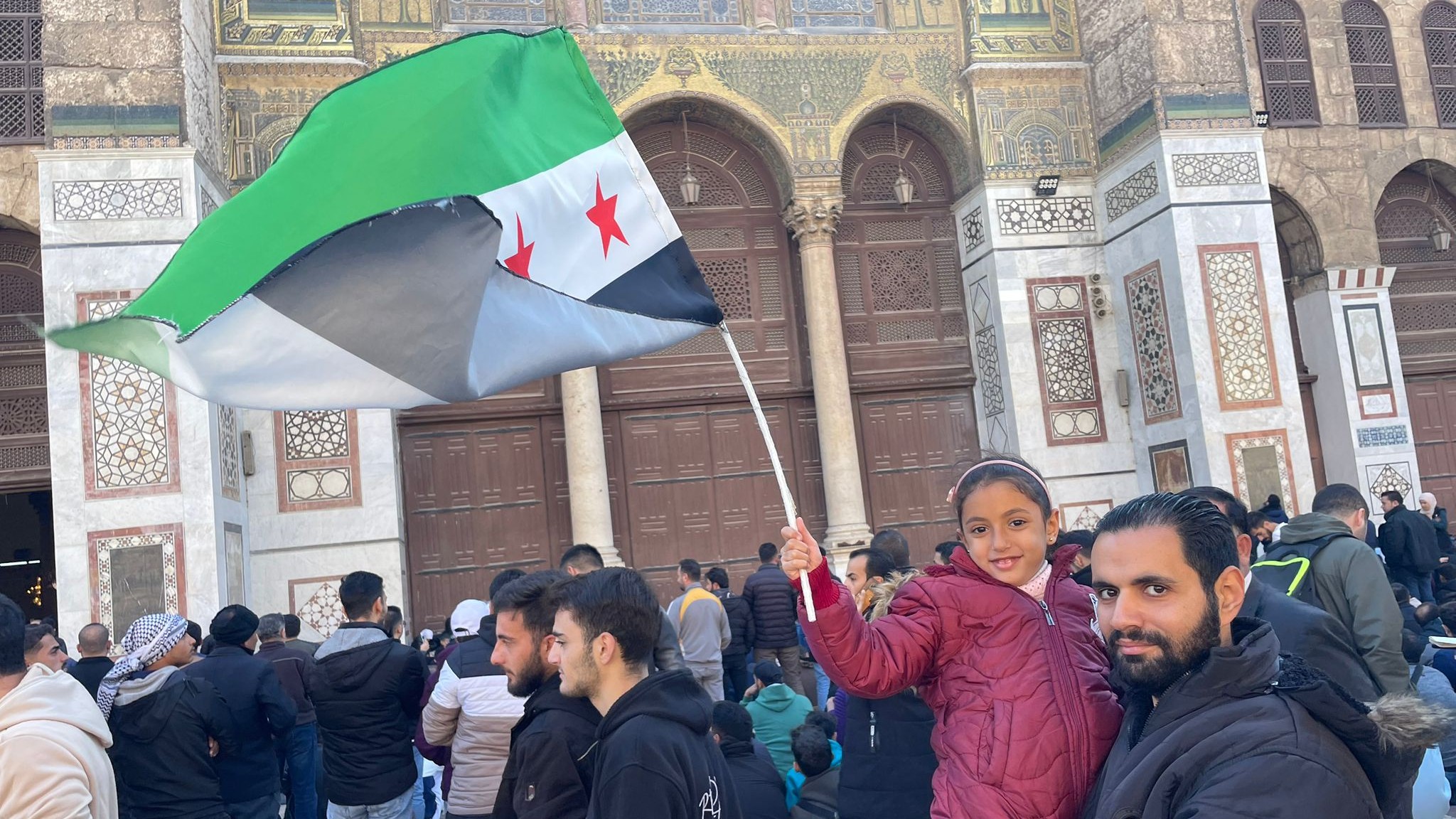 Worshippers at Umayyad Mosque hold revolutionary Syrian flag 
