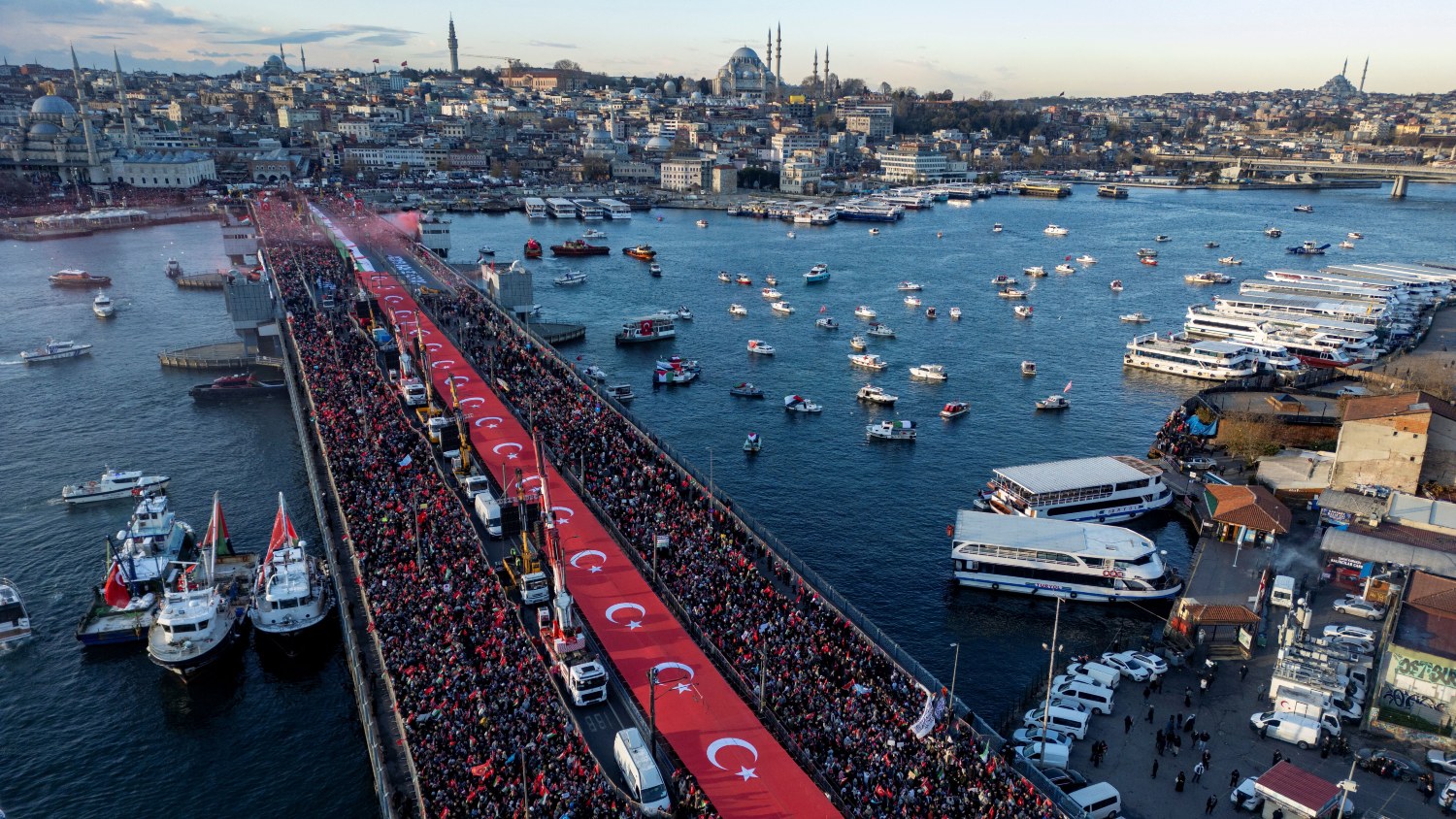 Aerial picture shows thousands of people demonstrating their solidarity with the Palestinian people at the Galata Bridge in Istanbul on January 1, 2026. Yasin AKGUL / AFP