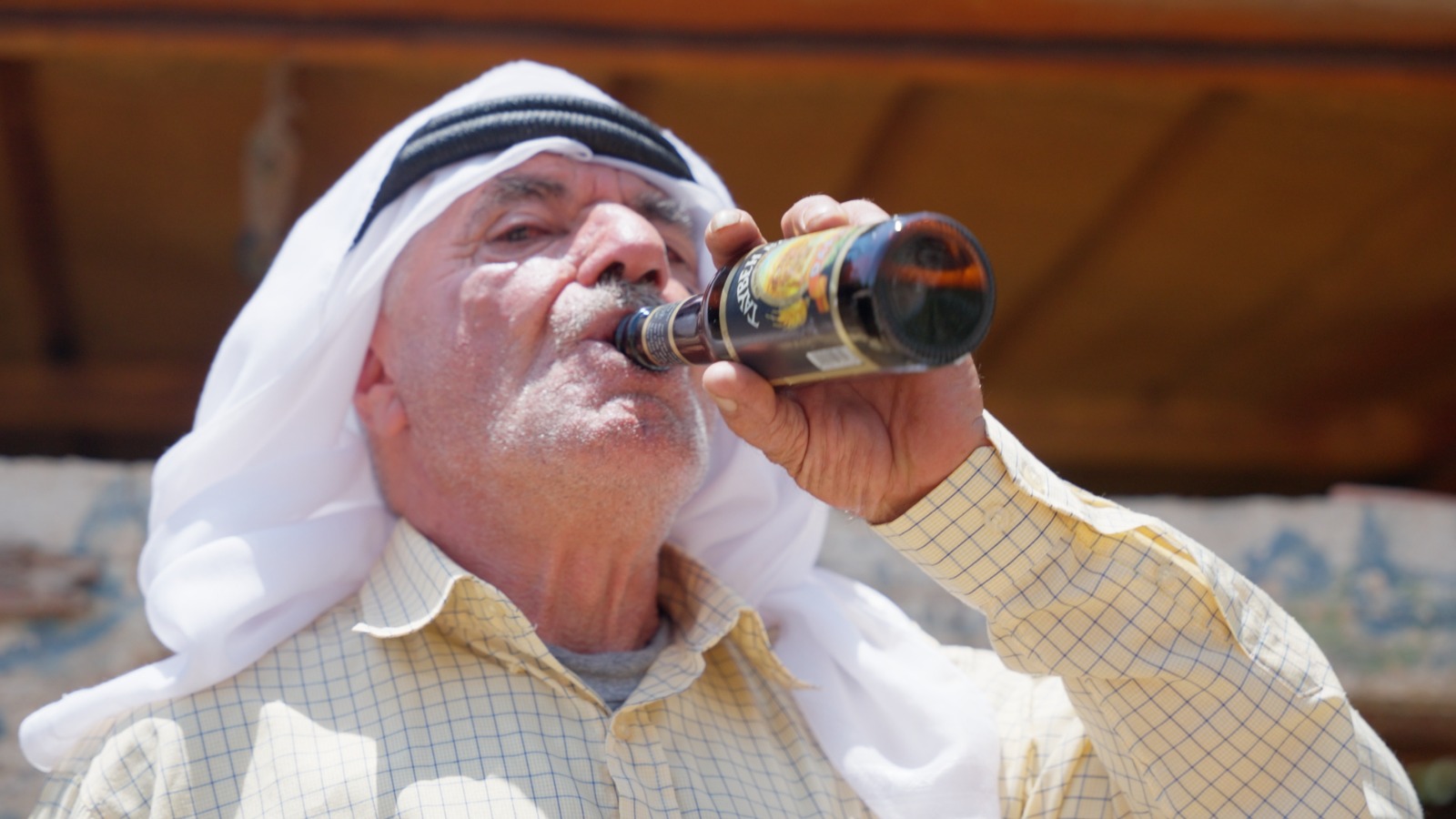 A man in the village of Taybeh drinking a local beer (supplied)