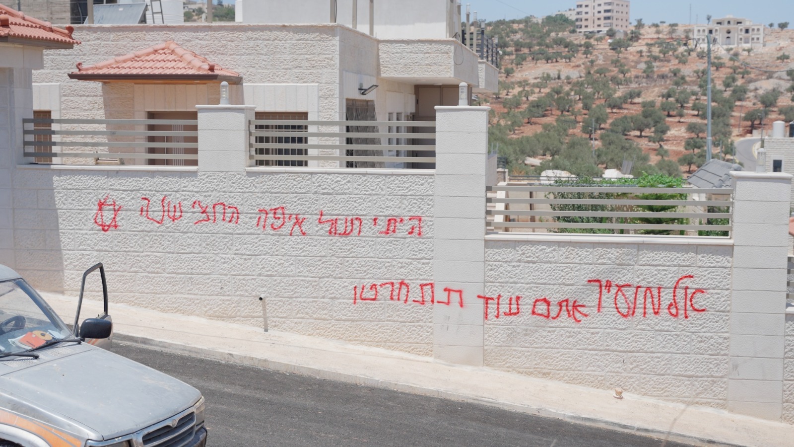 Racist graffiti sprayed by Israeli settlers marks a wall in Taybeh, occupied West Bank (supplied)