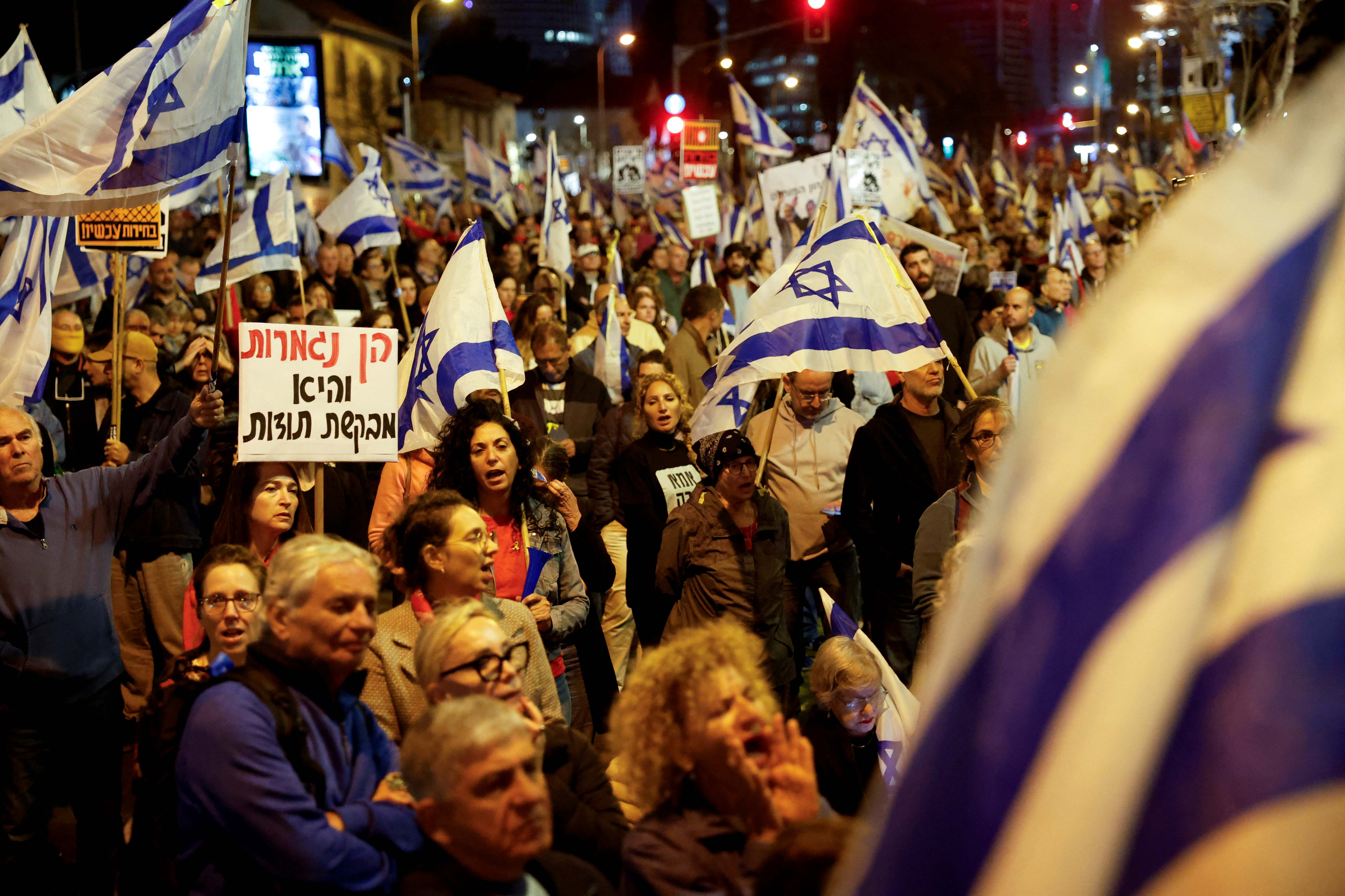 Demonstrators attend a protest against&nbsp;Israeli&nbsp;Prime Minister Benjamin Netanyahu's government on 23 March in Tel Aviv (Reuters/Carlos Garcia Rawlins)