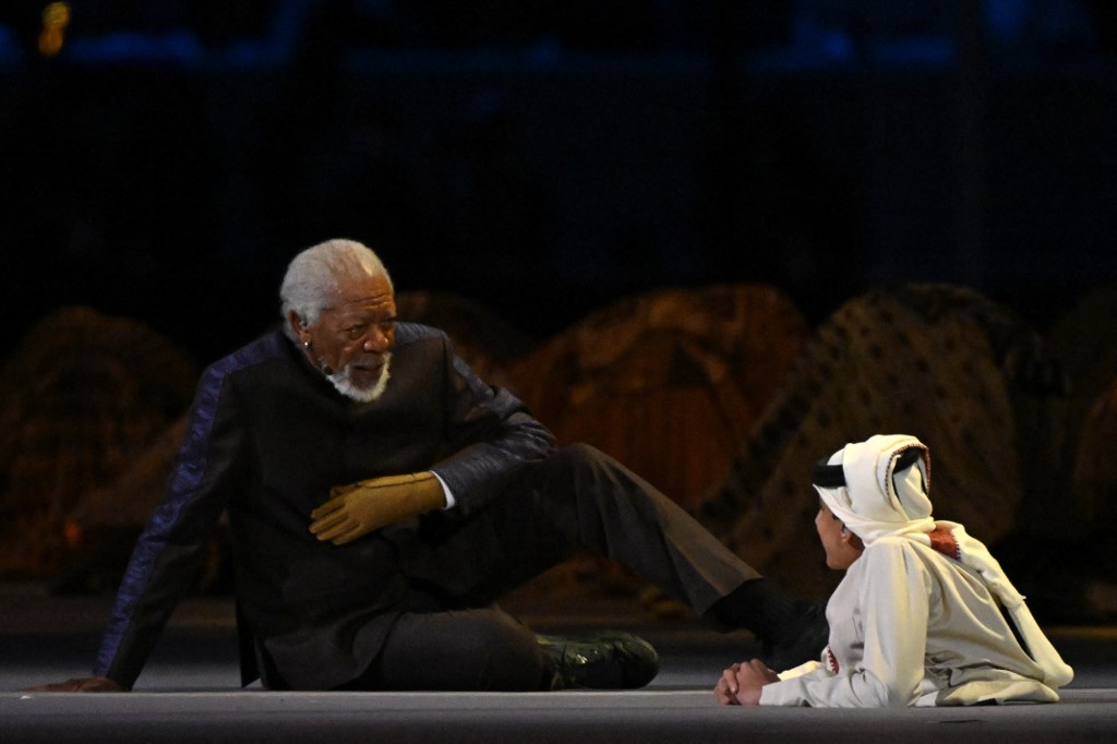 US actor Morgan Freeman (L) and Qatari Ghanim al-Muftah speak during the opening ceremony of the Qatar 2022 World Cup at the Al-Bayt Stadium, north of Doha, 20 November 2022 (AFP)