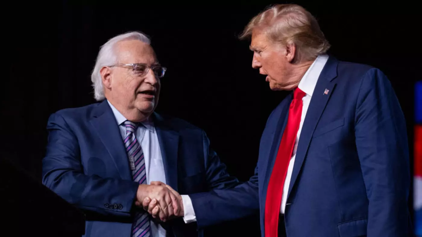 Former US President Donald Trump shakes hands with former US ambassador to Israel David Friedman in Nashville, Tennessee, on 22 February 22 2024 (AFP)