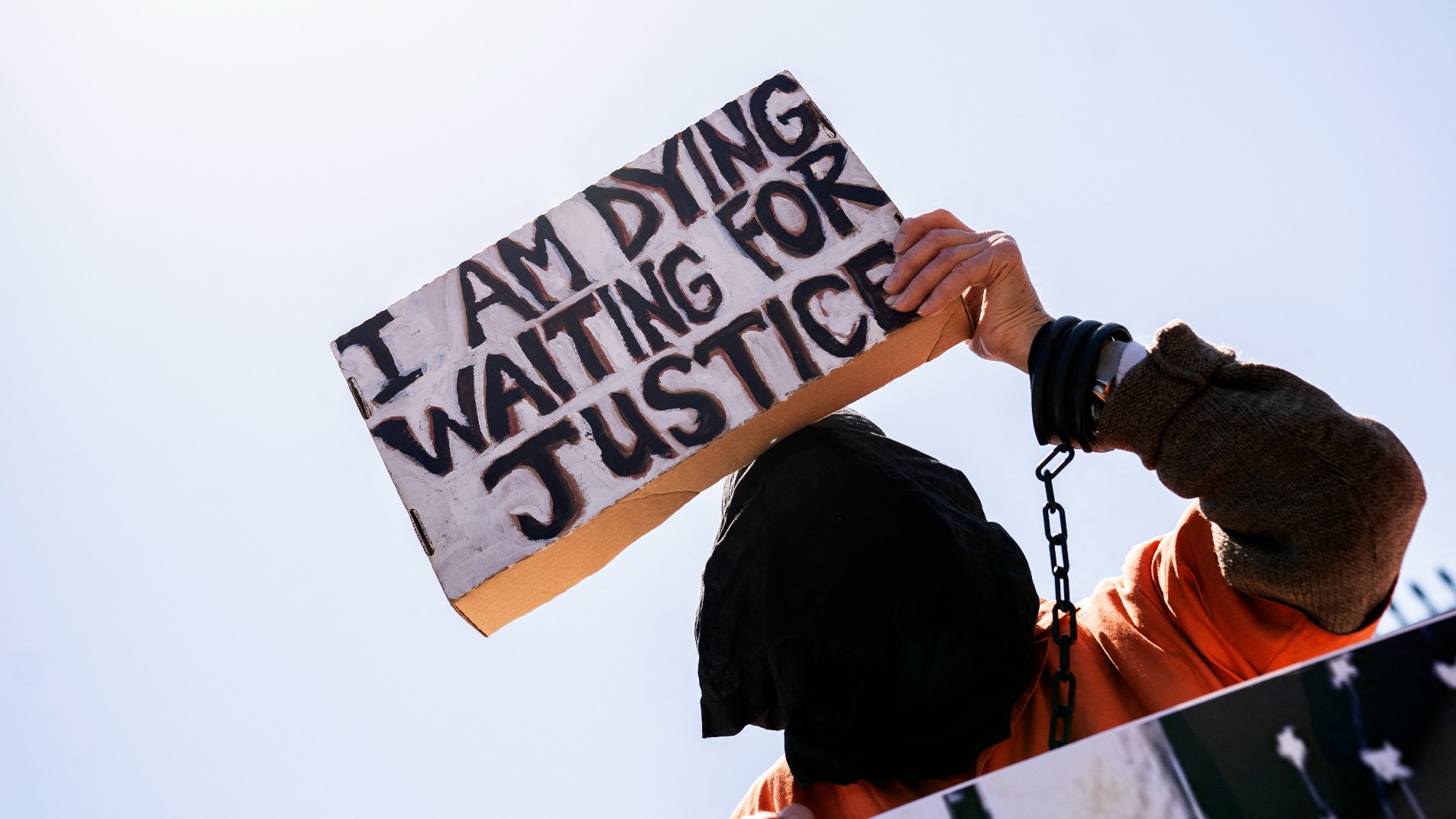 A demonstrator calling for the closure of the Guantanamo Bay detention facility holds a sign in front of the White House in Washington, DC, on April 2, 2022