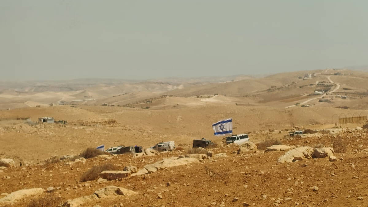 Settlers put an Israeli flag on land belonging to Nidal Jboor and his family  after they seized it (Photo supplied by Nidal Jboor)