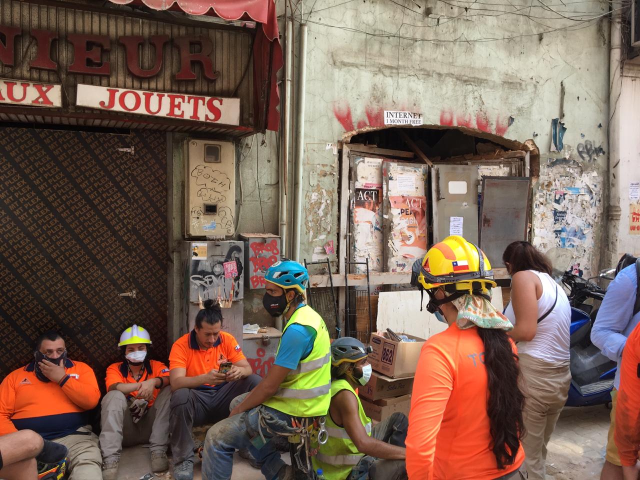 Rescue workers pause for a rest during a search operation in Beirut (MEE/Kareem Chehayeb)