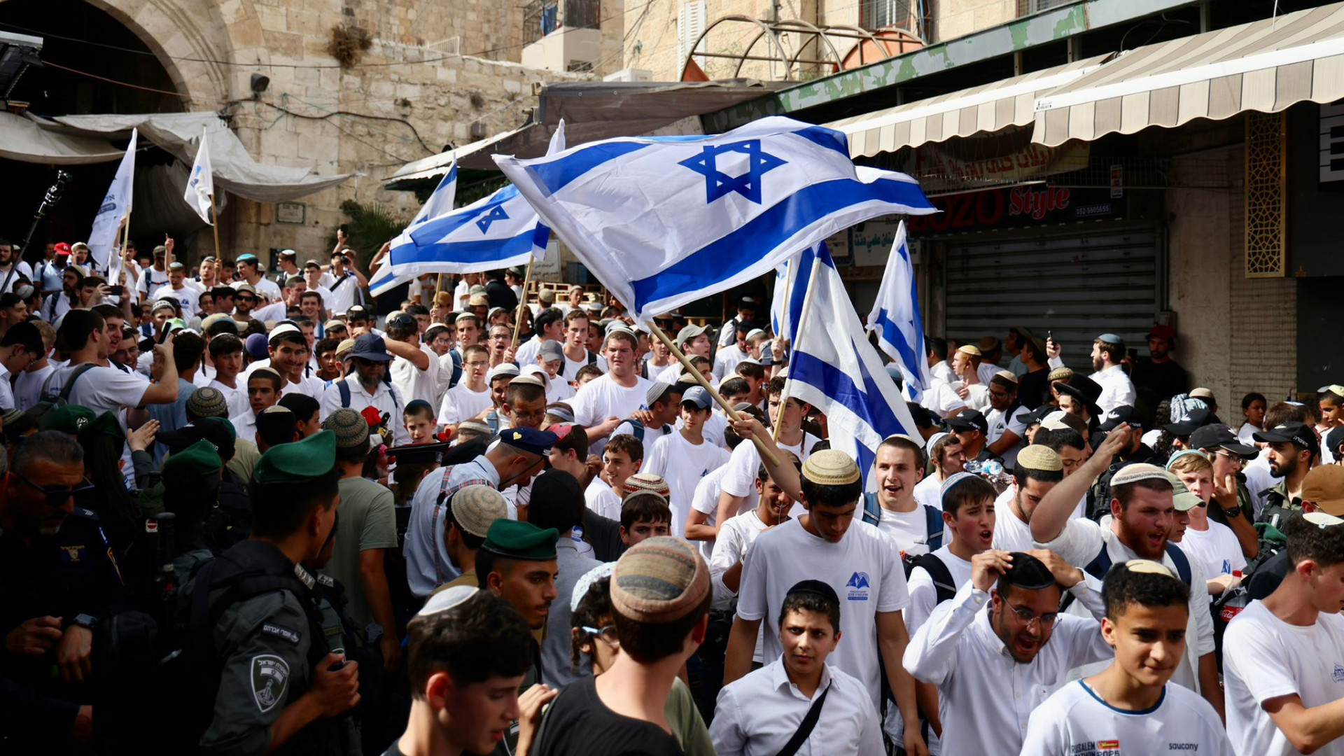 Ultra-nationalists raise the Israeli flag in the Old City in occupied East Jerusalem (MEE/Faiz Abu Rmeleh)