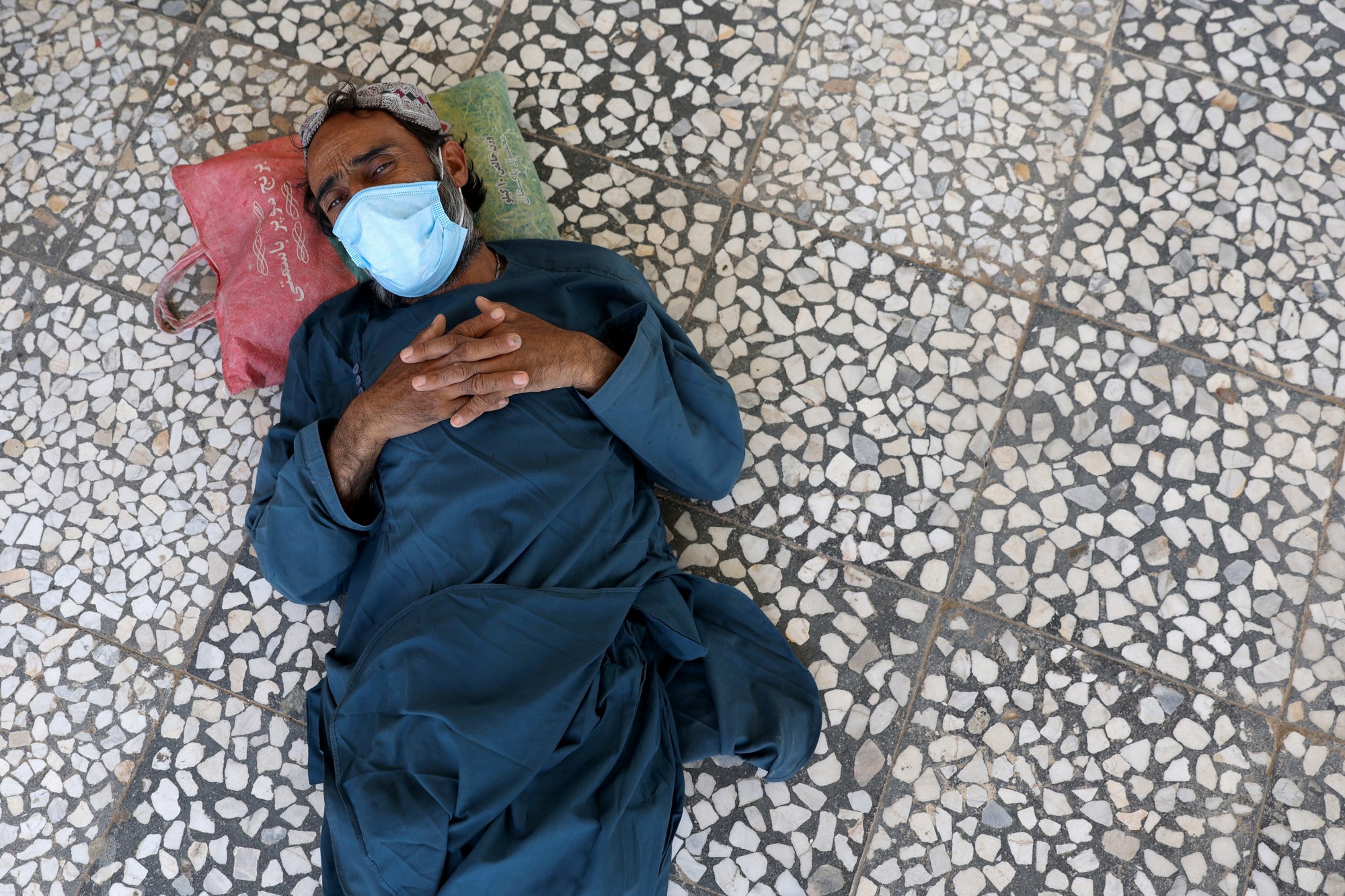 An Afghan man looks on as he lies on the floor at an Afghan refugee camp in Zahedan, Iran on 8 September 2021(Reuters/WANA)
