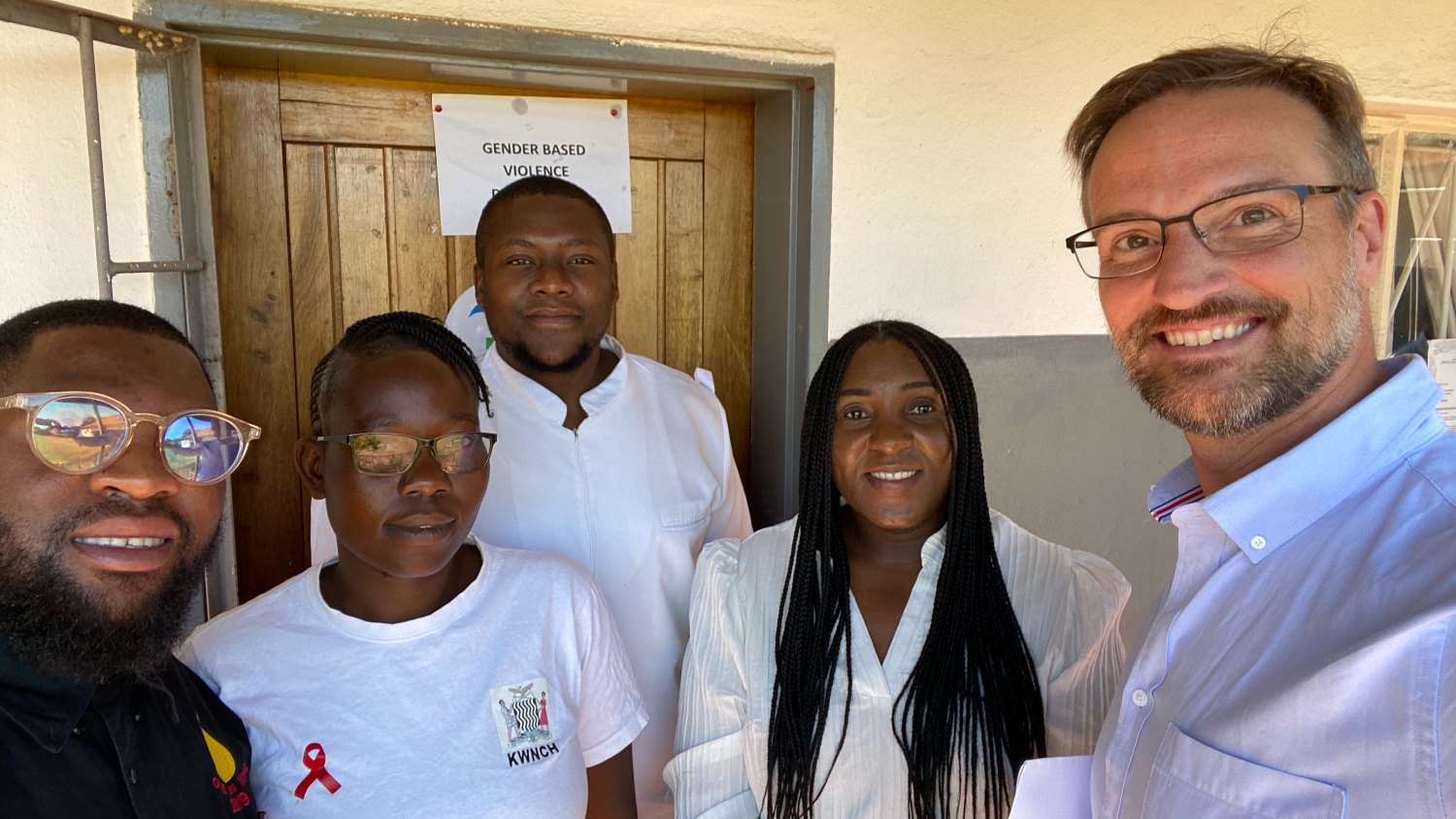 Alexander Smith poses for a photo with colleagues in Zambia in the first week of May 2024.