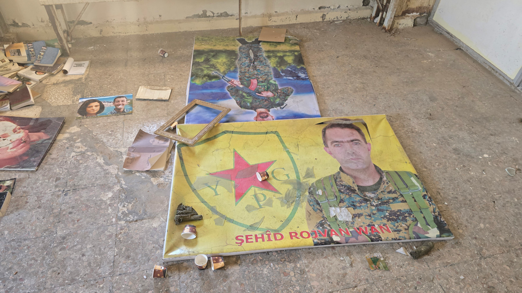 Posters of fallen Kurdish fighters can be see in an abandoned SDF compound in Raqqa, northeast Syria (Danny Makki/MEE)|