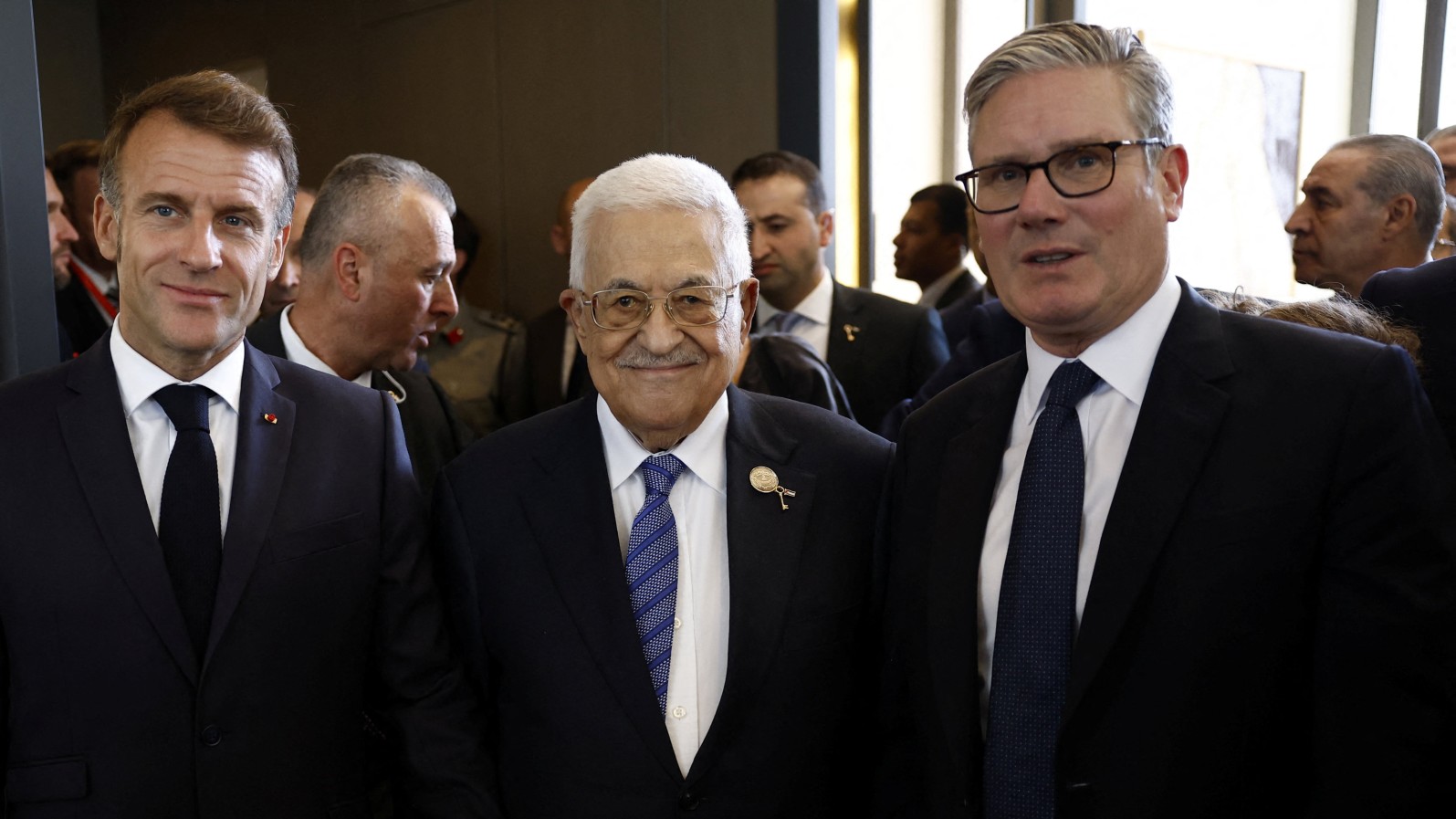 French President Emmanuel Macron, British Prime Minister Keir Starmer stand with Palestinian President Mahmoud Abbas before attending a world leaders' summit on ending the Gaza war, in Sharm el-Sheikh, Egypt, October 13, 2025. Yoan Valat/Pool via REUTERS