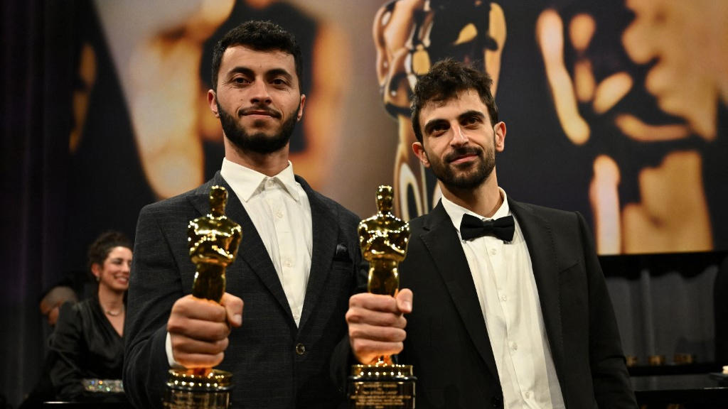 Filmmakers Basel Adra and Yuval Abraham attend the Oscars in Hollywood on 2 March 2025 (Angela Weiss/AFP)