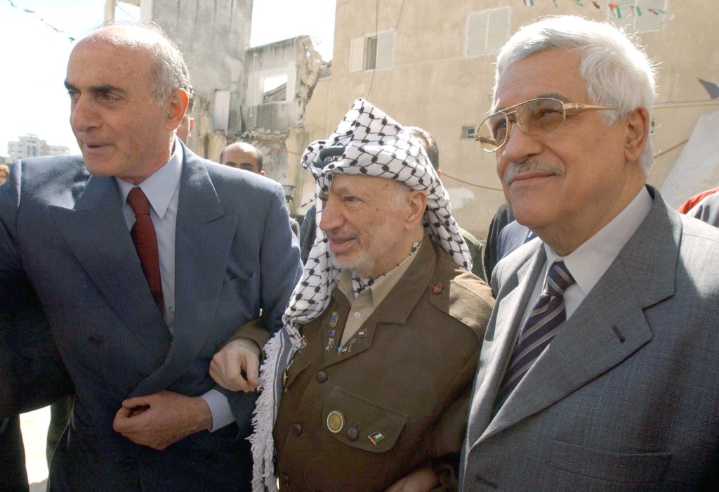 03 March 2003, Palestinian leader Yasser Arafat (C) arrives for a central council meeting along with prime minister Mahmud Abbas, Abu Mazen (R), and council member Munib al-Masri, at his battered headquarters in Ramallah.
