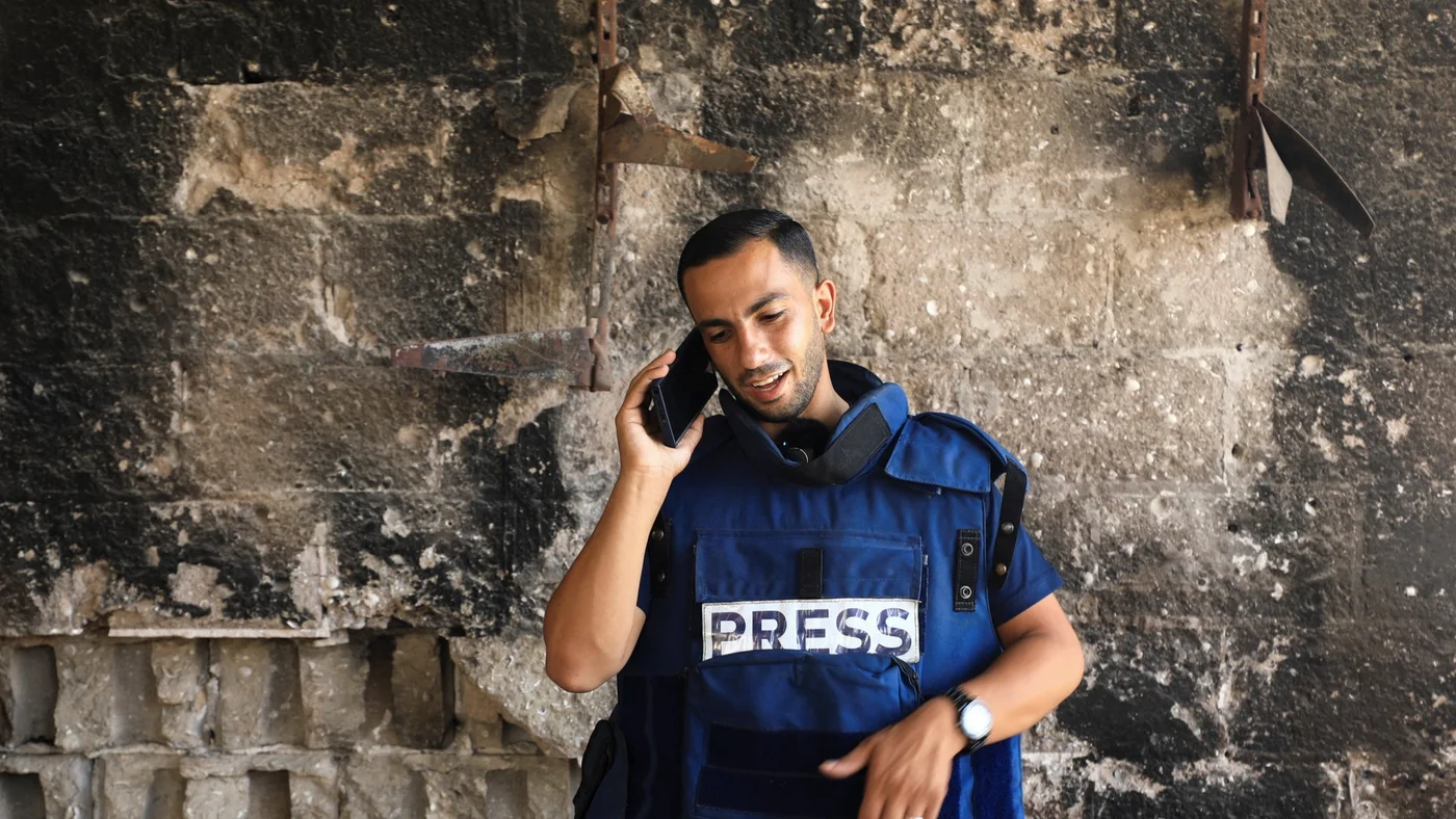 Al Jazeera journalist Anas Al Sharif, who was killed in an Israeli strike, speaks on the phone in Gaza City on 13 August 2024