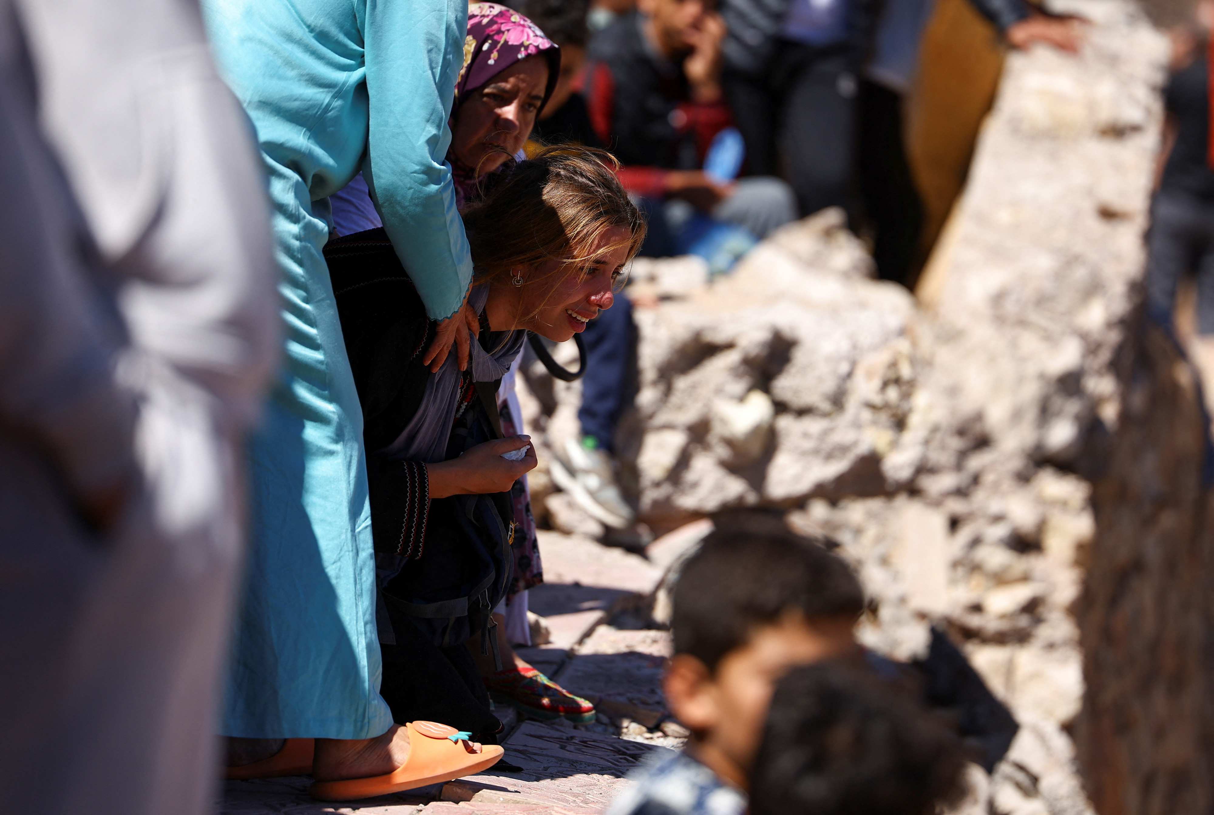 A daughter of one of two victims of the deadly earthquake reacts during their funeral, in Moulay Brahim, Morocco, 10 September 2023 (Reuters)