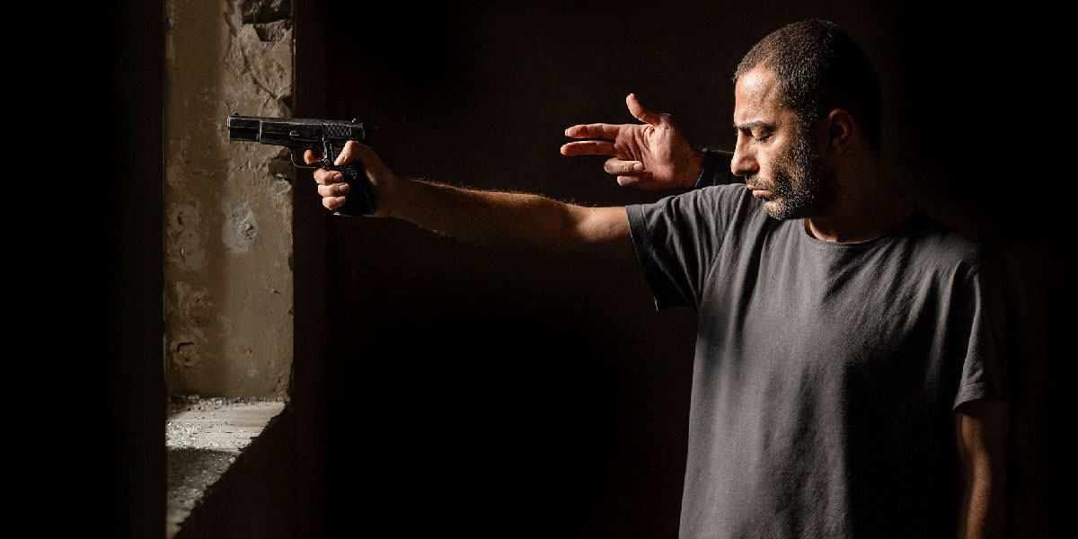 An Iranian woman walks past a sign showing the title of the 37th edition of the Fajr Film Festival in the capital Tehran on 3 February 2019 (AFP)