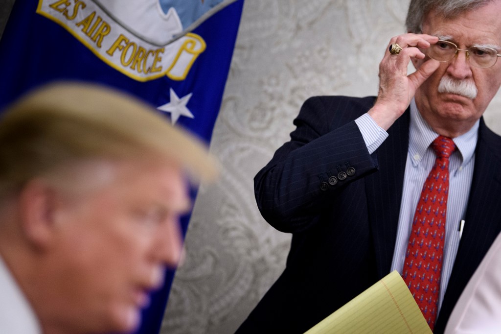 Bolton listens while US President Donald Trump speaks in Washington in May 2019 (AFP)