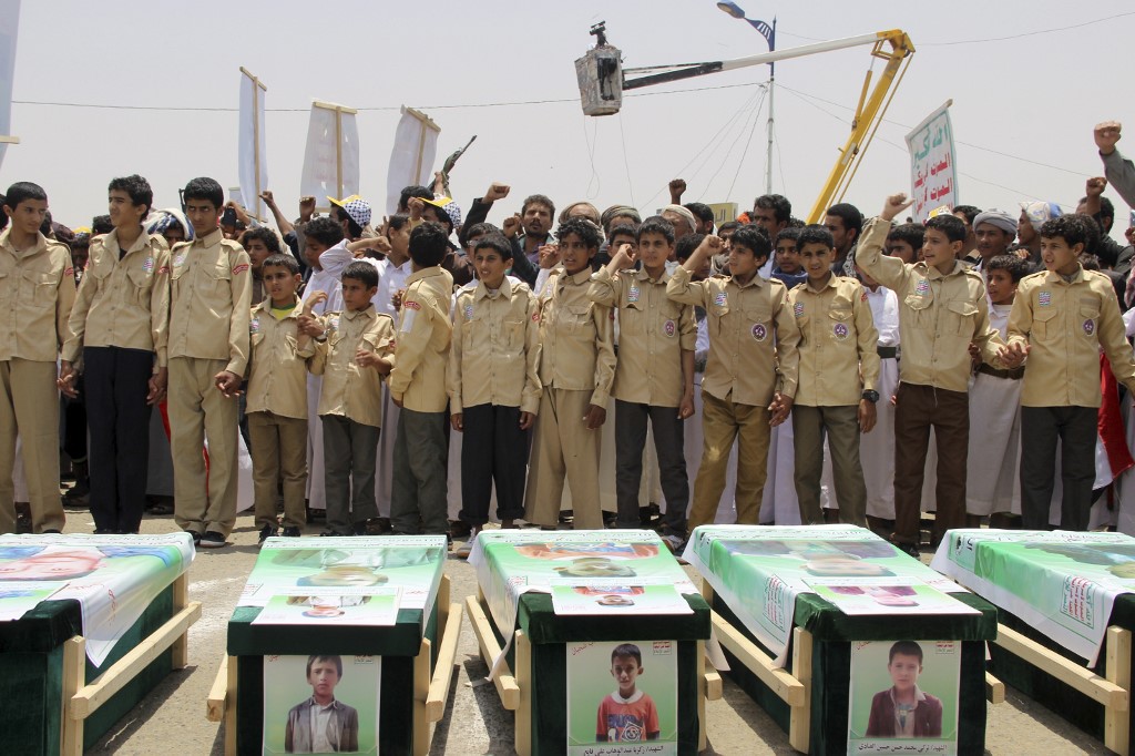  A mass funeral is held in Saada for children killed in a Saudi-led coalition air strike in August 2018 (AFP)