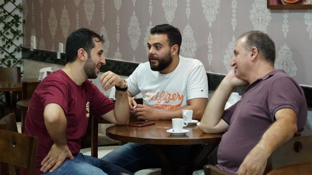 Customers throng to Albaraa Hamou's Arabic-themed coffee shop for the sweets and pastries on offer (MEE/Eman Abusidu)