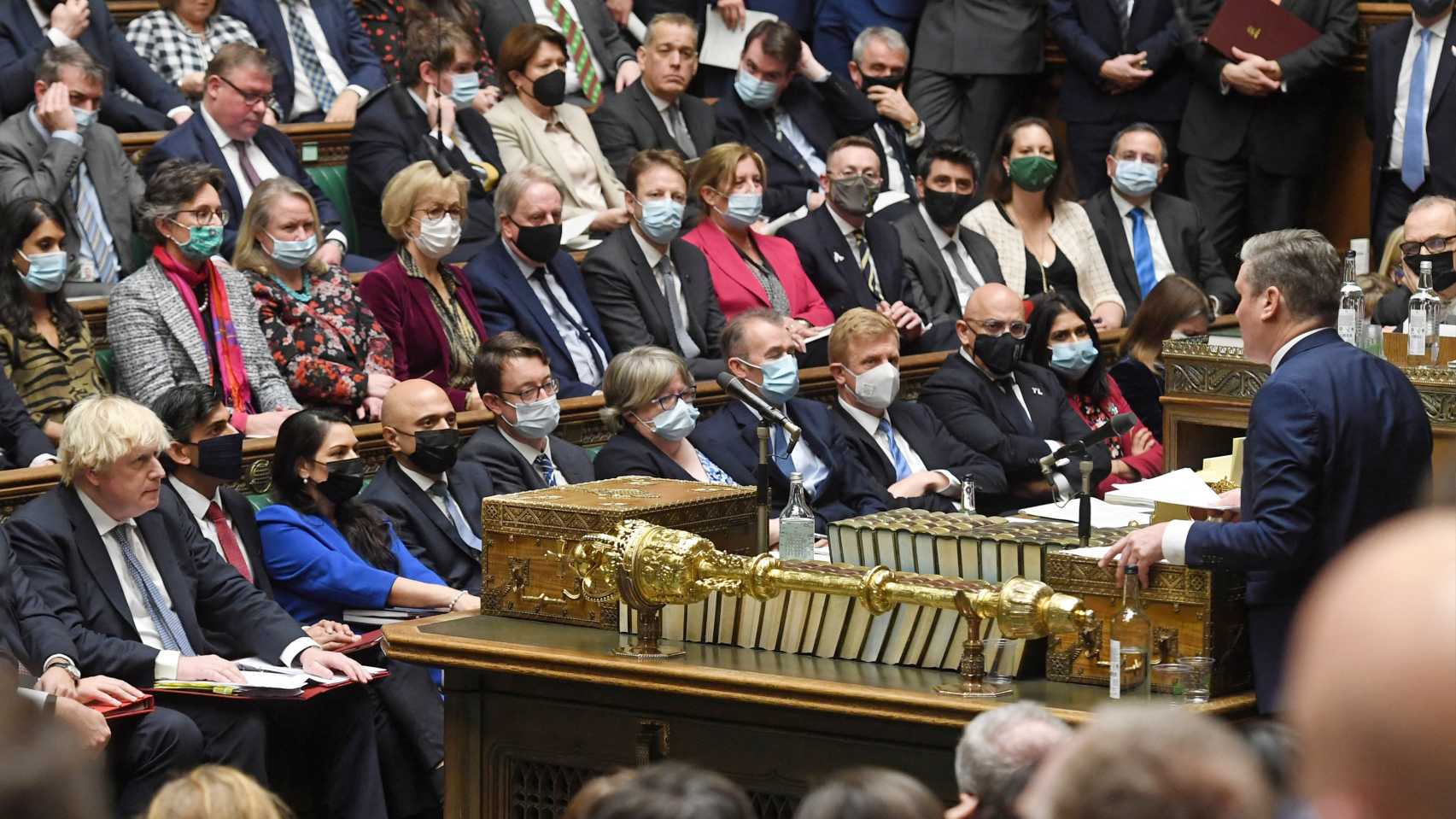 Britain's main opposition Labour Party leader Keir Starmer (R) speaks during Prime Minister's Questions (PMQs) in the House of Commons in London on December 8, 2021. 