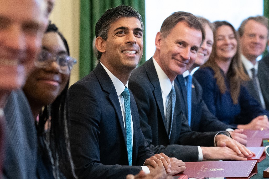 Sunak poses for a photo with members of his cabinet in London on 26 October 2022 (AFP)