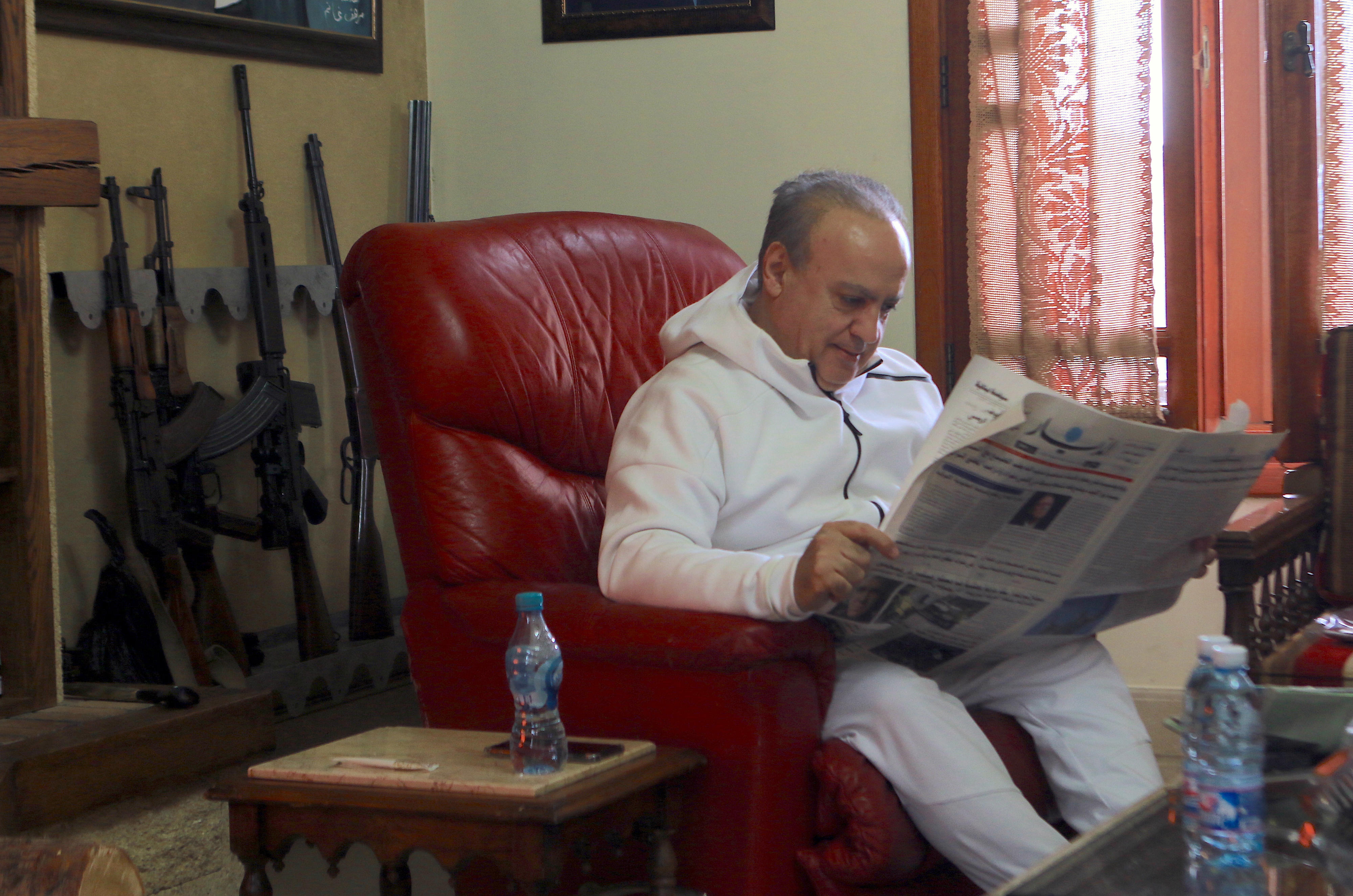 Wiam Wahhab reads a Lebanese newspaper in his home in Jahlieh (MEE/Michal Kranz)