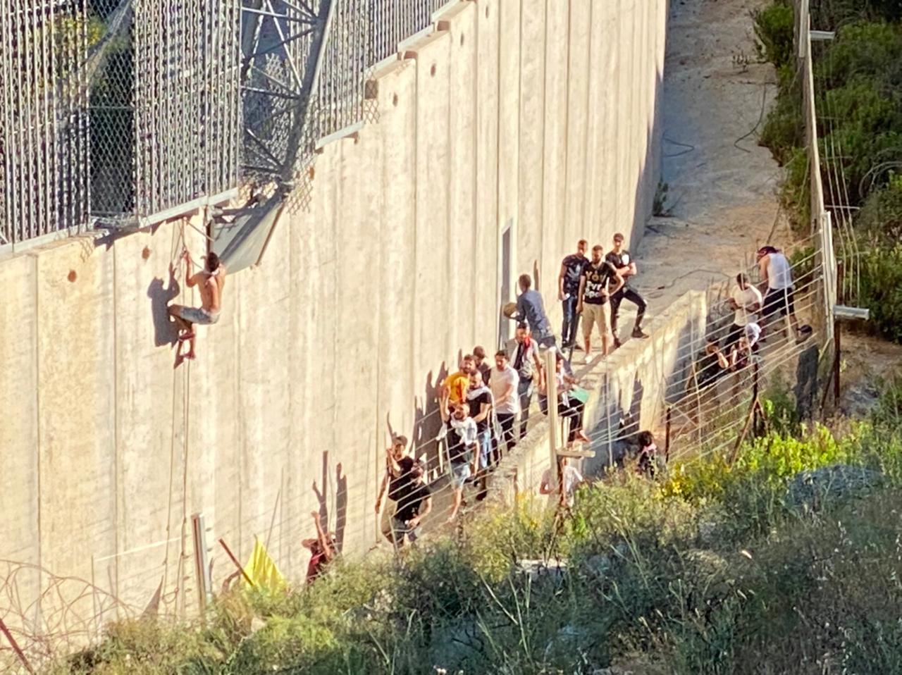 Lebanon man scaling Israel border wall