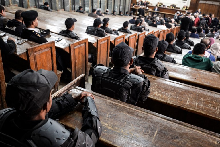 Members of the Egyptian security forces sit in a Cairo courthouse on 2 December (AFP)