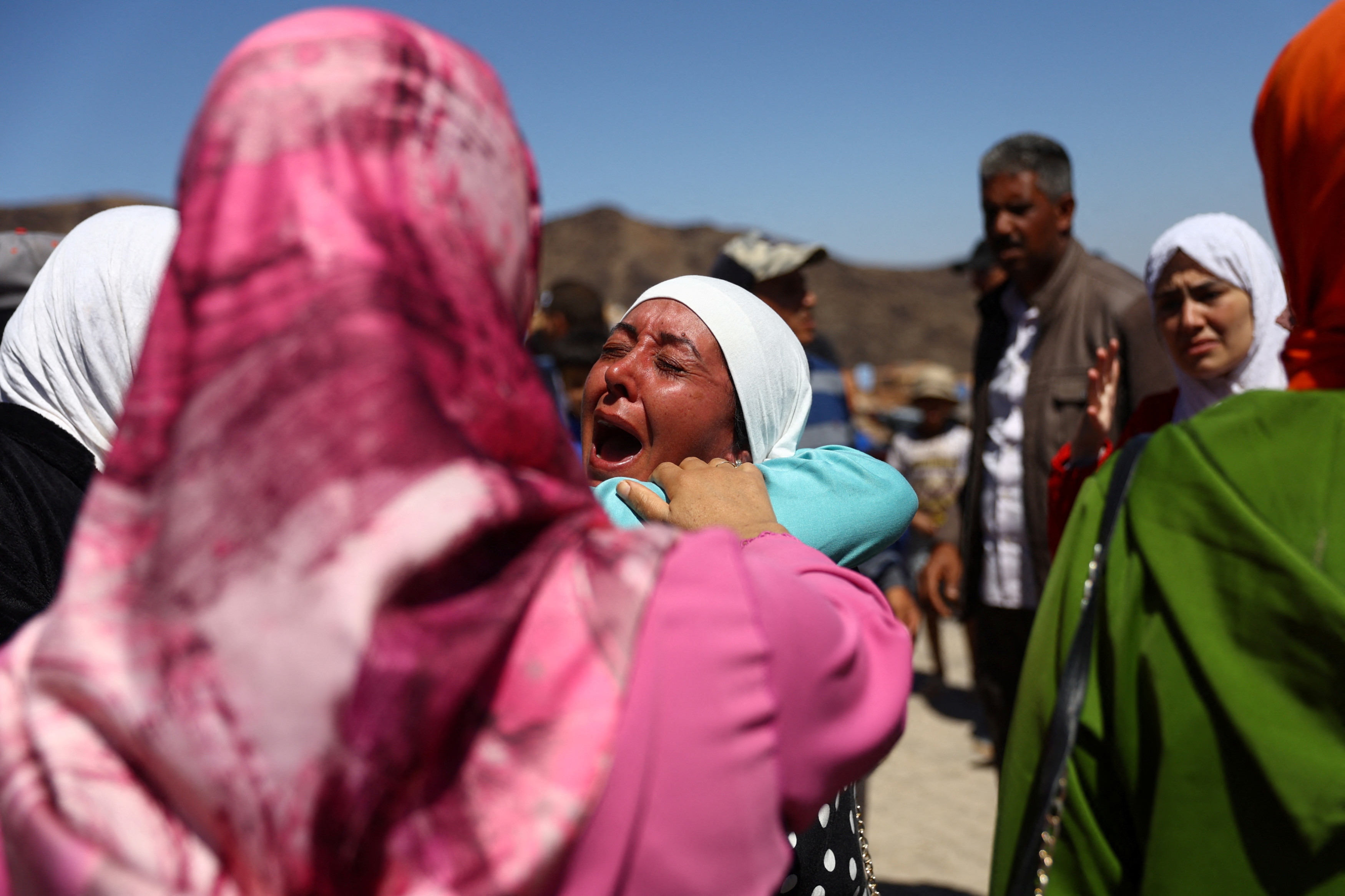People react during the funeral of two victims of the deadly earthquake, in Moulay Brahim, Morocco, 10 September 2023 (Reuters)