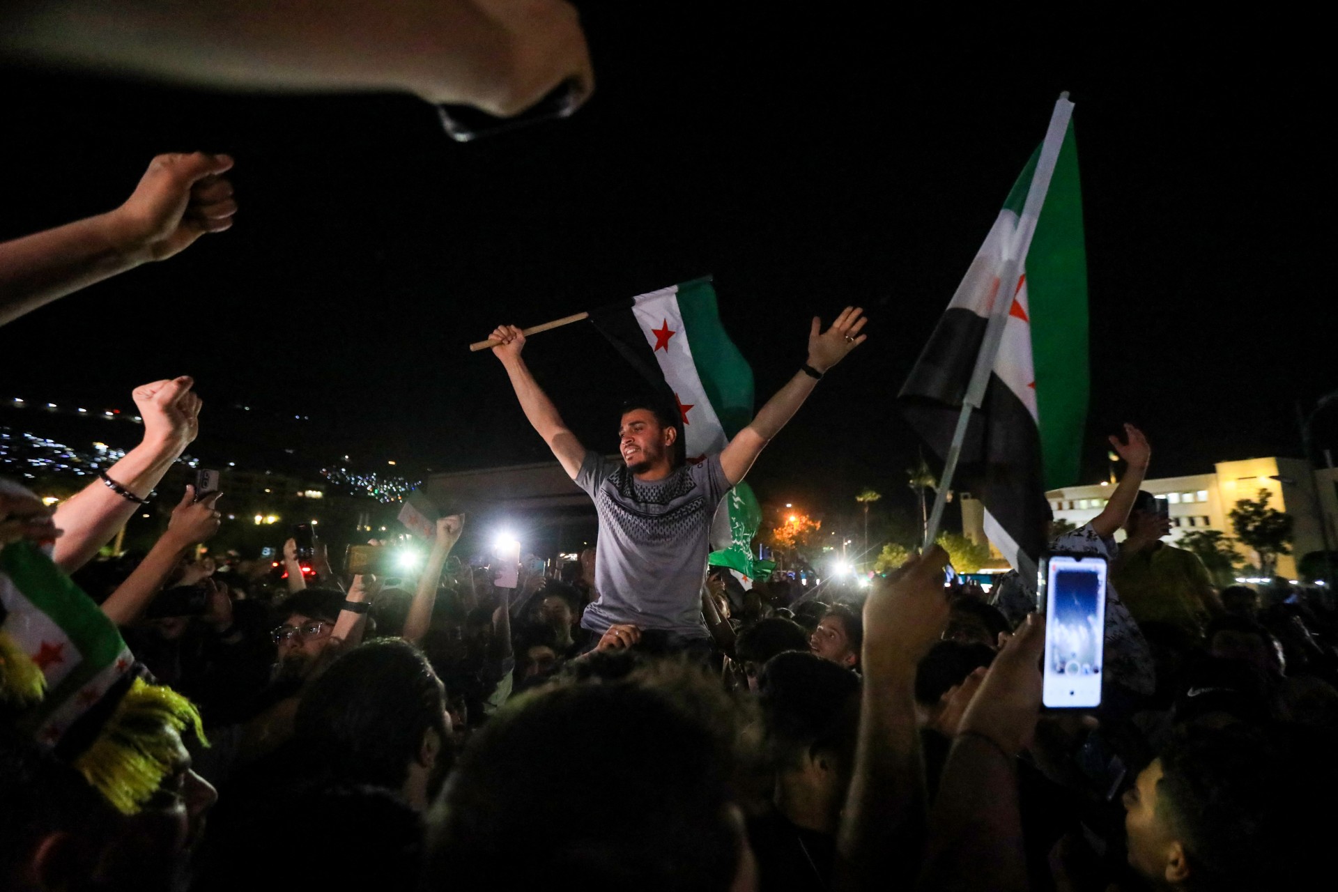 People celebrate in Damascus' Umayyad square after US President Donald Trump's decision to lift sanctions in Syria, on 13 May 2025 (AFP/Bakr al-Kassem)