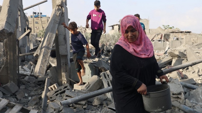 Palestinians inspect the damage after overnight Israeli strikes on Rafah in the southern Gaza Strip on October 22, 2023