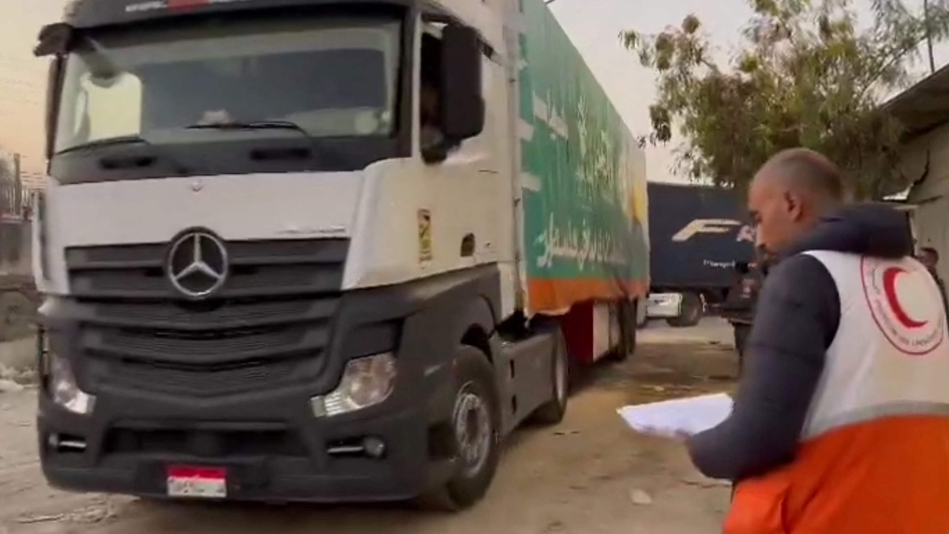 Red Crescent official inspecting aid truck entering Gaza via Rafah crossing in Egypt (Reuters)