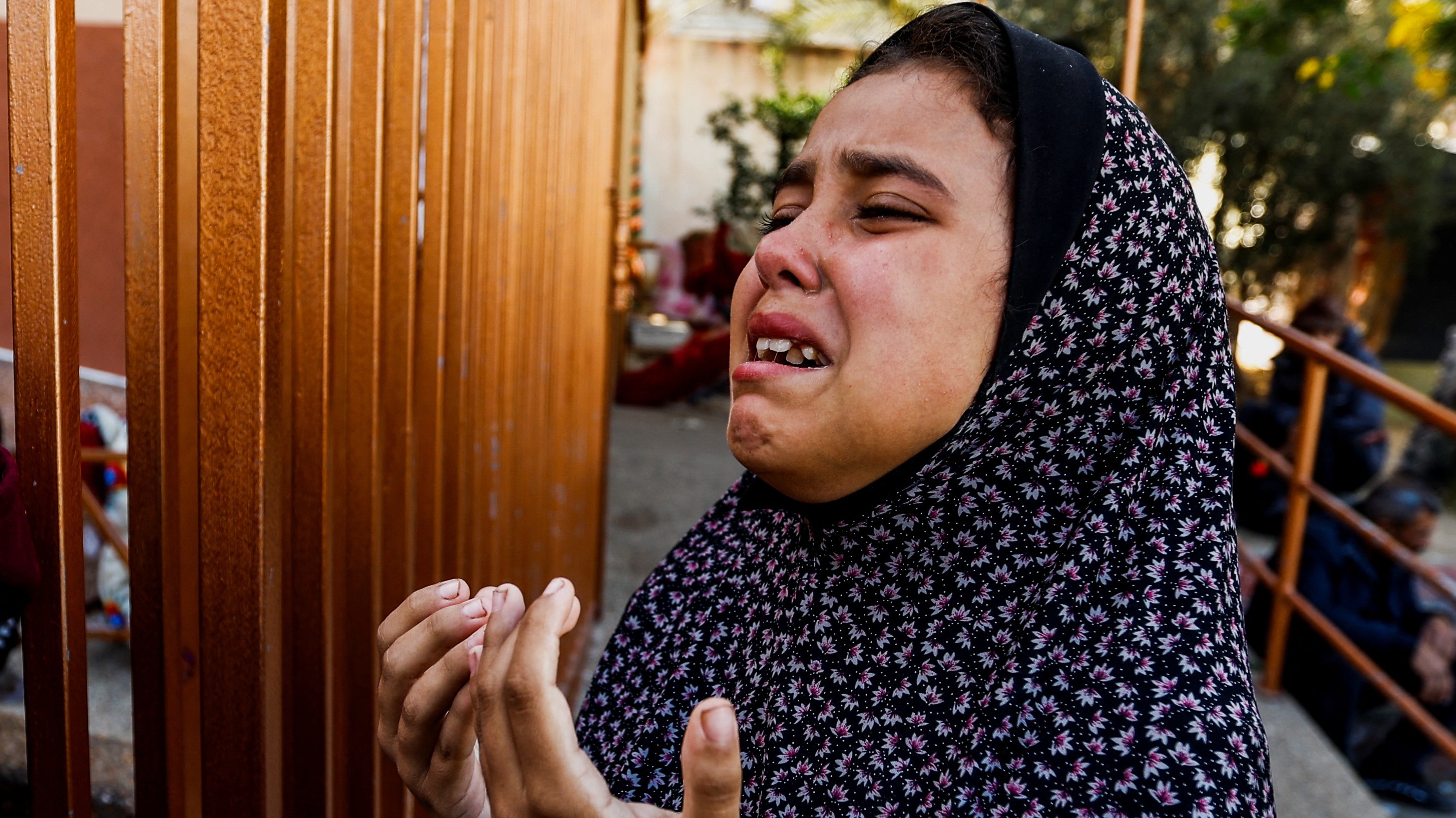 A girl mourns during a funeral for Palestinians killed in Israeli strikes, at Nasser hospital in Khan Younis