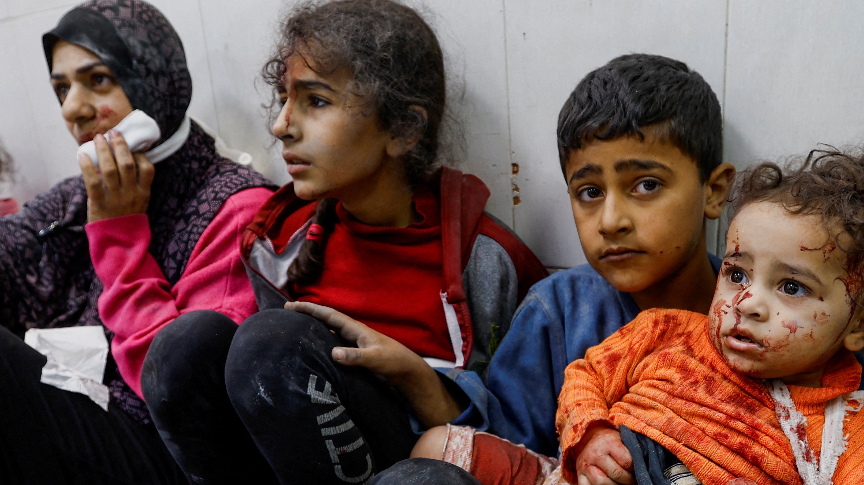 Wounded Palestinians sit on the floor at Nasser hospital following Israeli strikes in Khan Younis in the southern Gaza Strip (Reuters/Ibraheem Abu Mustafa)