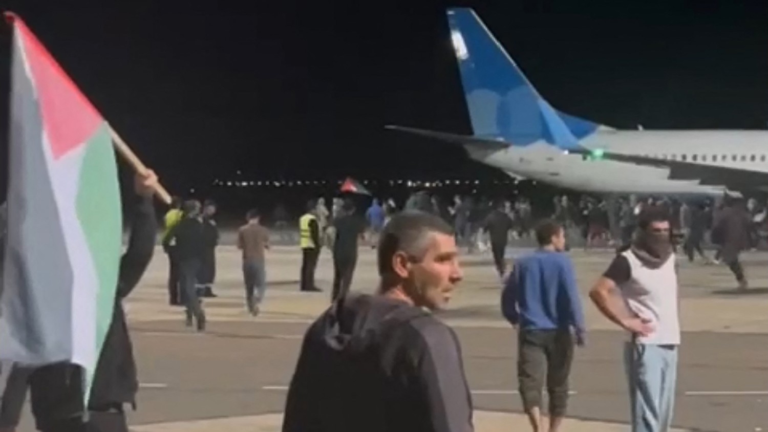 A screengrab taken from video footage posted on a Telegram channel on 29 October 2023 shows protestors on the apron area of an airport in Makhachkala, Dagestan.