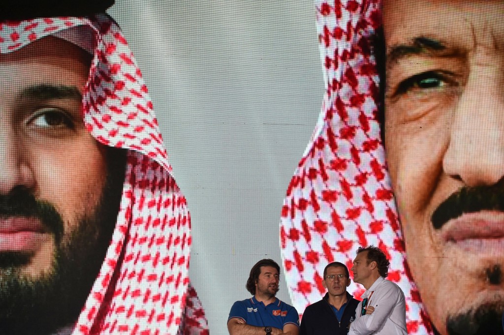 Portraits of Saudi Crown Prince Mohammed bin Salman and Saudi King Salman bin Abdulaziz are displayed in Jeddah on 4 January ahead of the Dakar Rally (AFP)