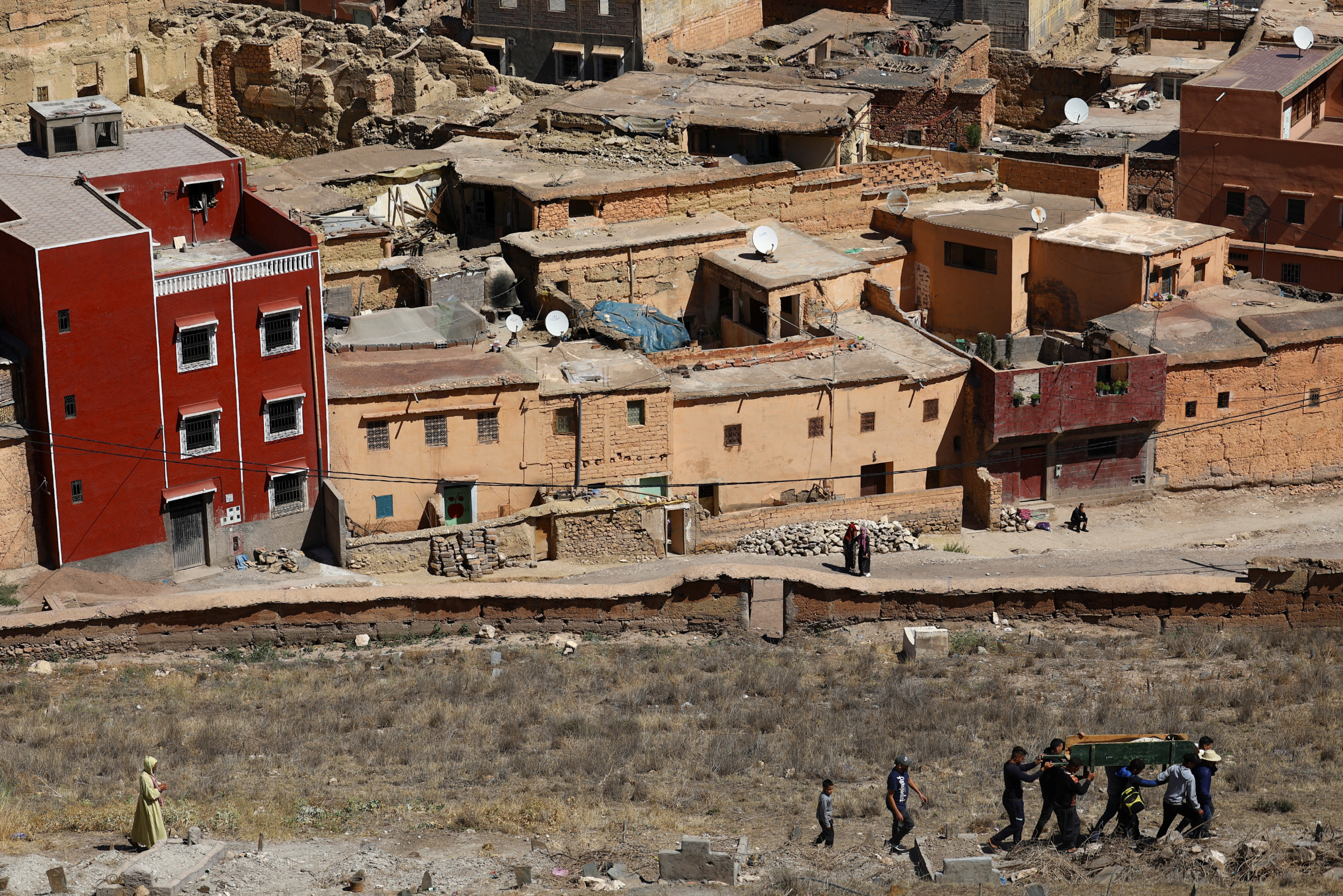 People attend the funeral of two victims of the deadly earthquake, in Moulay Brahim, Morocco, 10 September 2023 (Reuters)