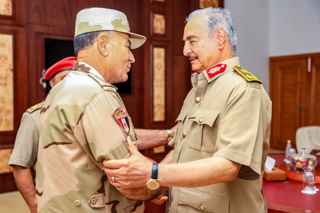 This picture released by the official Facebook page of Egypt's Military Spokesman on September 12, 2023 shows Libya's eastern military strongman Khalifa Haftar (R) receiving the Chief of Staff of the Egyptian Armed Forces Lieutenant General Osama Askar in Libya's eastern city of Benghazi, after the latter arrived with a military delegation and emergency disaster relief aid in the wake of massive floods by Mediterranean storm 