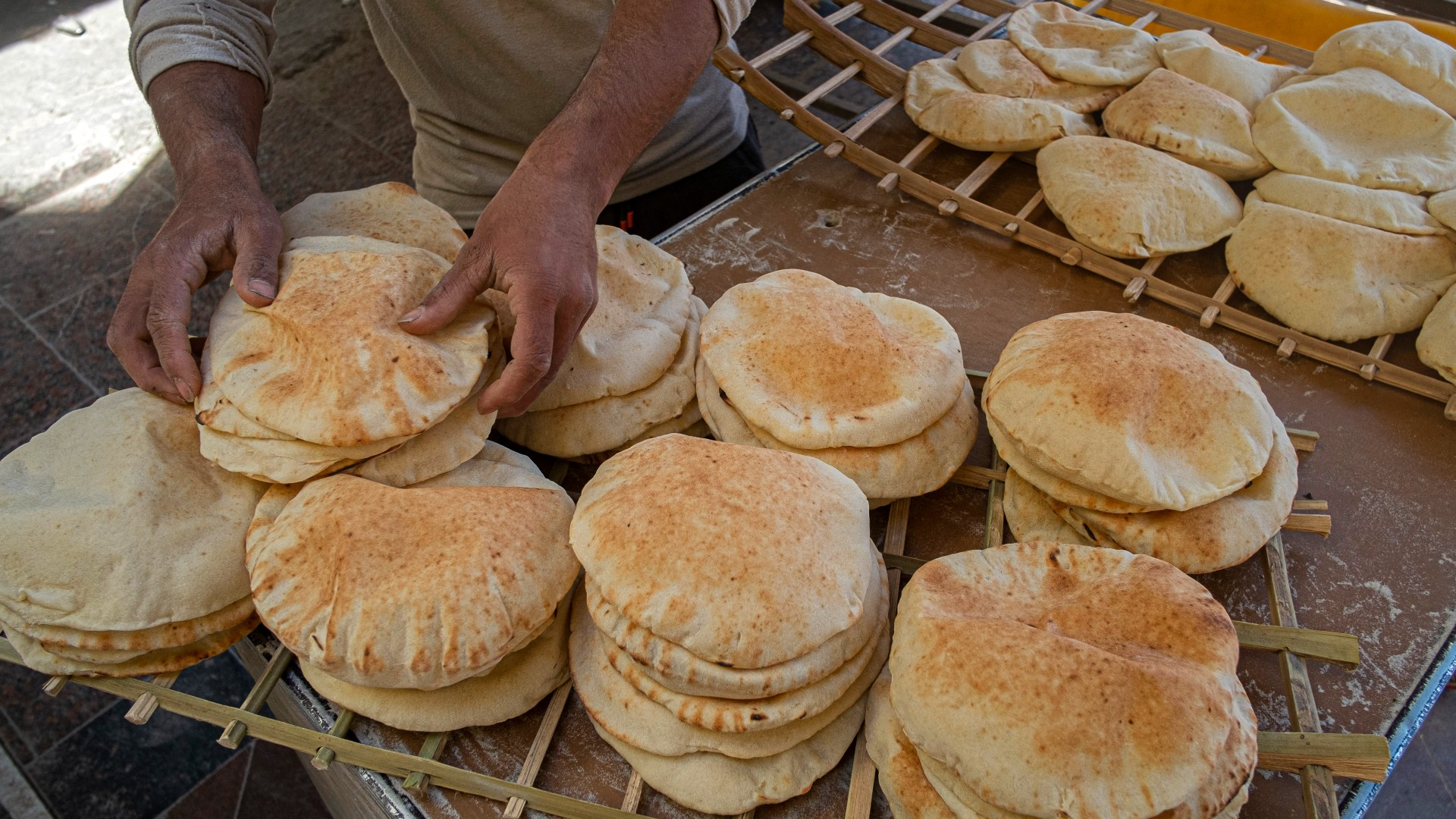Egyptian men work in a bakery at a market in Cairo, on March 17, 2022. Soaring bread prices sparked by Russia's invasion of Ukraine have bitten into the purchasing power of consumers in Egypt