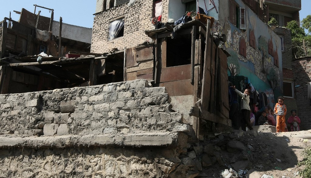 Egyptian children play outside their home in a Cairo slum in March 2011 (AFP)