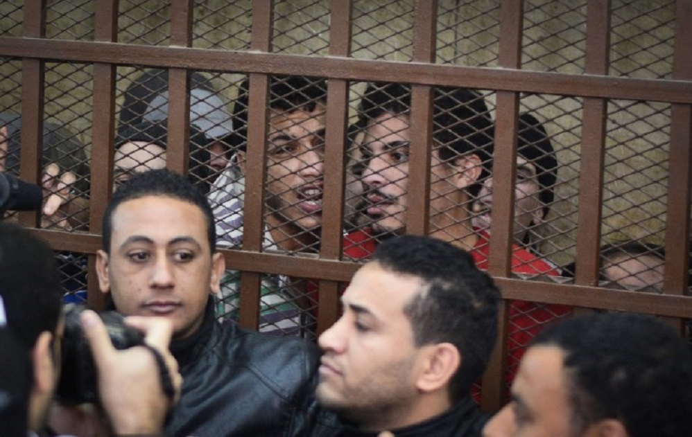Defendants react behind the bars at a court in Cairo following the acquittal on 12 January 2015 of 26 men accused of 