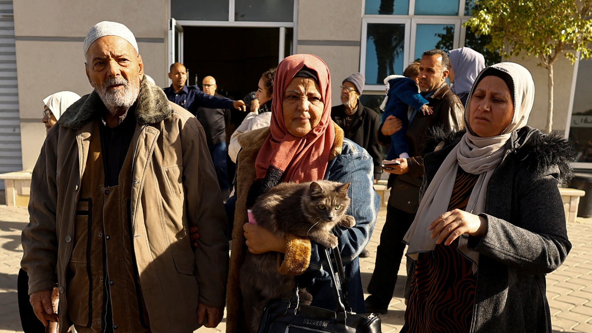 Palestinians with foreign passports arrive at the Rafah border crossing with Egypt, in Rafah in the southern Gaza Strip, November 23, 2023.