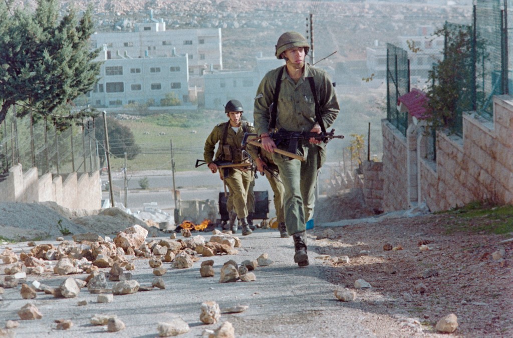 Israeli soldiers patrol Nablus amid demonstrations during the First Intifada in 1987 (AFP)