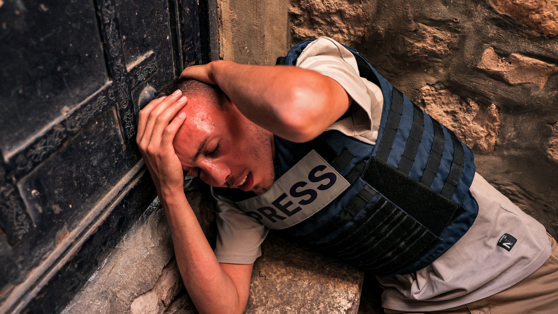 Palestinian freelance journalist Saif Kwasmi reacts after being assaulted by Israeli right-wing youth during the 'flag march' in Jerusalem 5 June (AFP/Hazem Bader)