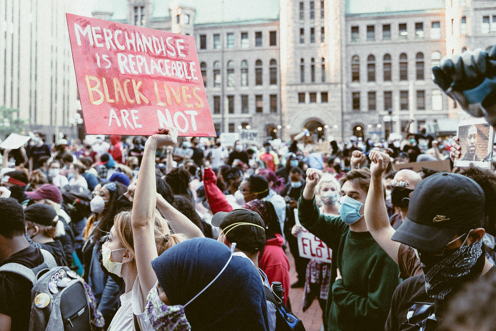 Crowds standing in demonstration in a Minneapolis street.