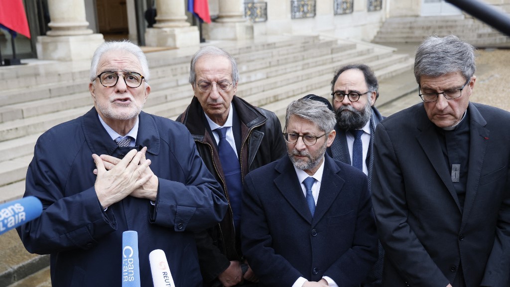Rector of the Great Mosque of Paris, Chems-eddine Hafiz (L), flanked by Archbishop of Reims and President of the Conference des Eveques de France (CEF - Bishops' Conference of France) Eric de Moulins-Beaufort (R), Grand Rabbi of France Haim Korsia (C), President of the Orientation Council of the Foundation of Islam of France (FORIF) Sadek Beloucif (2ndL), addresses media during a press conference after a meeting between France's President and France's religious representatives at the presidential Elysee Pal