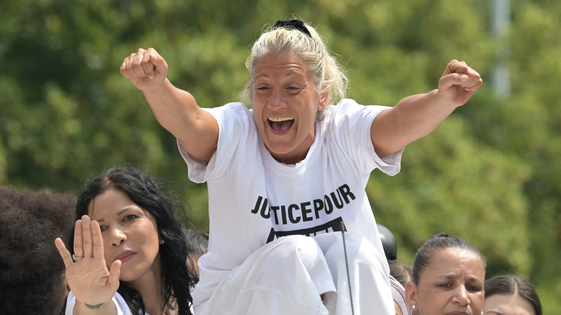 Mounia, the mother of teenager Nahel M who was shot dead by police, addresses crowds at a vigil in Nanterre (AFP)