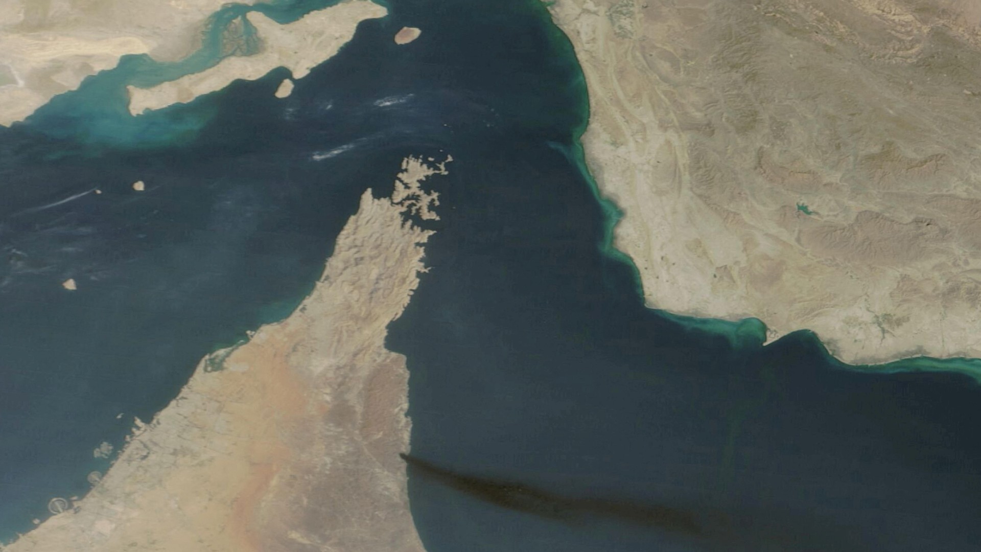 Satellite image shows smoke rising from UAE's Fujairah port and the Straight of Hormuz, 15 March 2026 (Nasa Worldview via Reuters)