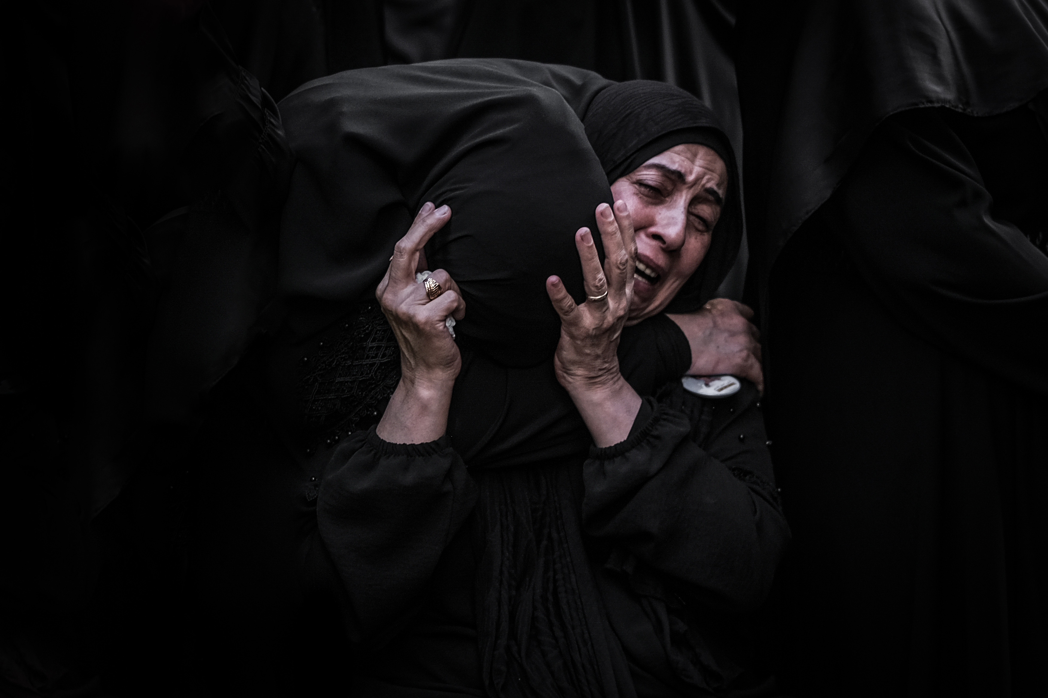 Women mourn relatives during a funeral for the victims of the pagers attack held in Ghobeiry, Beirut, 17 September 2024 (Joao Sousa/MEE)